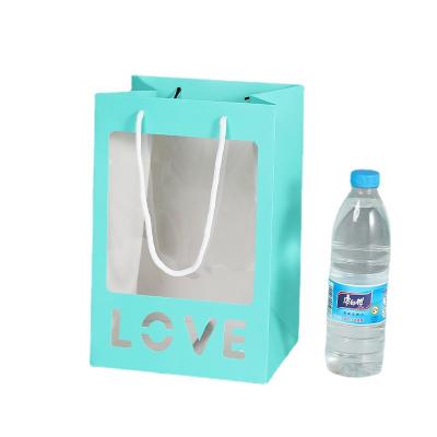 China Mini Lollipop Bouquet Open Window Viewfinder Vertical Transparent Tote Paper Bag Recyclable Wholesale Handheld Bag for sale