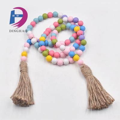 China Wooden Colorful Wooden Garland with Jute Tassels Natural Rustic Sweet Candy Bead Twine Wooden Hanging for sale