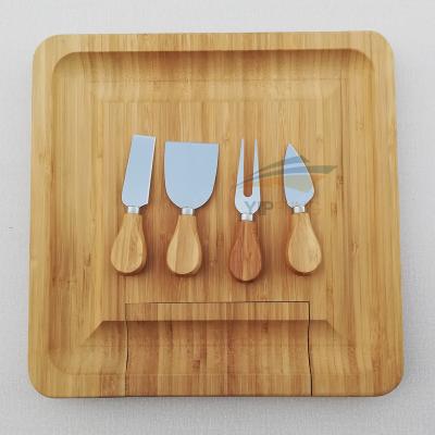 China Viable Hot Seller Multifunctional Wholesale Oval Bamboo Cheese Cutting Board With Slide-out Drawer And 3 Knives for sale