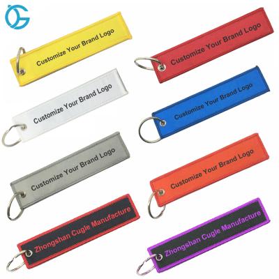 China Promotional Cheap Fabric Pilot Hotel And Factory Resort Gift Woven Tags Embroidery Key Chain for sale