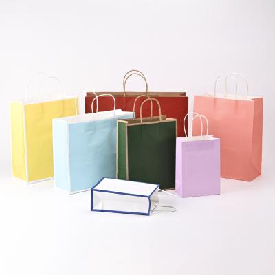 China Recycled Materials Custom Printed White Brown Colorful Kraft Paper Bags with Handles for Gift Shopping Food Paper Gift Bags for sale