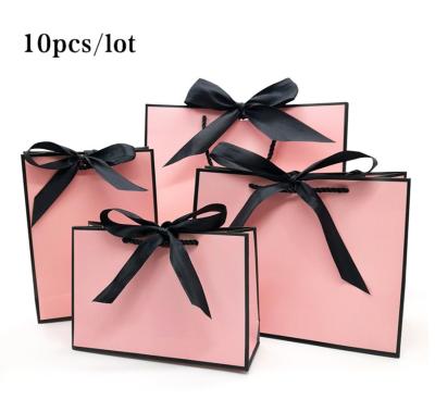 China Pretty Recyclable Pink Kraft Gift Bag Gold Present Box For Pajamas Clothes Books Packaging Gold Handle Paper Box Bags Kraft Paper Gift Bag for sale