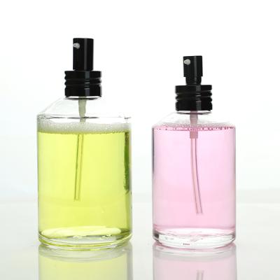 China Custom OEM Boston Style Round Glass Clear Bottles With Pump For Essential Oil Skin Care for sale