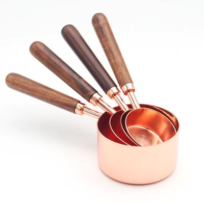 China 9 Piece Sustainable Copper Stainless Steel Rose Gold Measuring Cups Set With Wooden Handle for sale