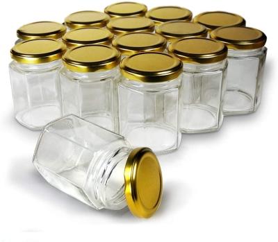 China Freshness Keeping Hexagon Small Jars Gold Lid Glass Jars For Jam Honey Jelly Wedding Favors for sale