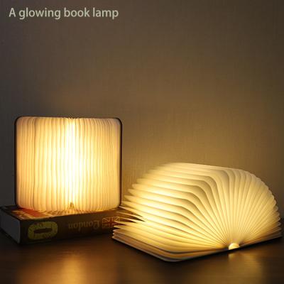 China It may be 180 Â ° and 360 Â ° New wholesale mini folding book lamp bedroom bedside book shape desk lamp. for sale