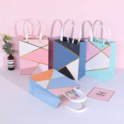 China Recyclable Luxury Rivet Metal Button Paper Shopping Bag with Logo Print for Perfume Delicate Handbag for sale