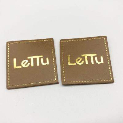 China Washable Custom Foil Stamping PU Leather Label Patches Wholesale Leather Iron On Leather Label For Garment for sale