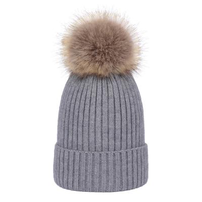 China Custom Leather Fleece Striped Winter Rib Knitted Pompom Beanie Hat JOINT Womens Girls Badge With Faux Fur Pom Pom for sale