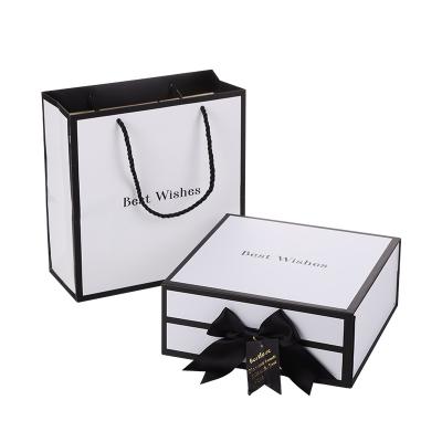 China Recycled Materials High-end Black And White Luxury Folding Magnetic Paper Box Wedding Dress Packaging Box With Paper Bag for sale