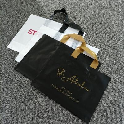 China Recyclable Soft Loop Handle Plastic Clothing Tote Shopping Bag With Custom Logo for sale