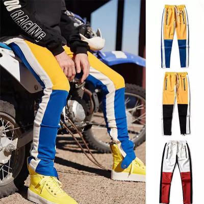 China Anti-wrinkle sweatpants contrast color patch side zipper zipper pockets an elastic waistband custom color block edge zipper track pants men's for sale