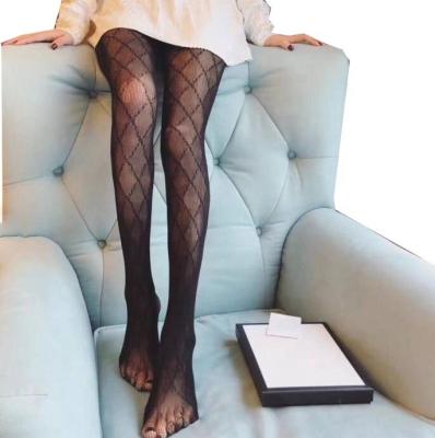 China Designer Letters Print Ladies Breathable Tights Stocking Mesh Breathable Black Pantyhose For Women for sale