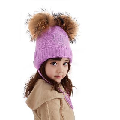 China Winter Two Color Custom Raccoon Fur Pompom COMMON Soft Knit Fur Earflap Beanies Hat For Kids Girl for sale