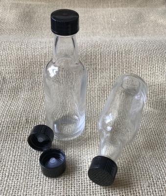 China 50ml sustainable glass bottle with plastic lid, spirit glass bottle for sale