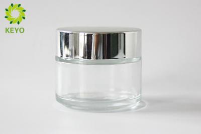 China Thick Wall Clear Glass Face Cream Jars 100g Round Shape With Silver Color Cap for sale