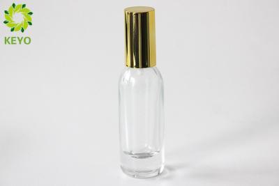 China Clear Glass Foundation Bottle 30ml Thick Bottom Type With Gold Aluminium Pump for sale