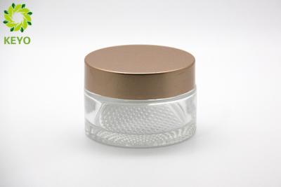 China 100g Clear Glass Cream Jars Thick Bottom Wide Mouth Type With Golden Plastic Cap for sale