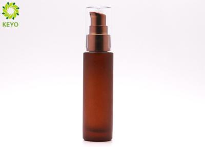 China Brown Glass Cosmetic Essential Oil Bottle With Electroplating Brown Plastic Pump Cap for sale