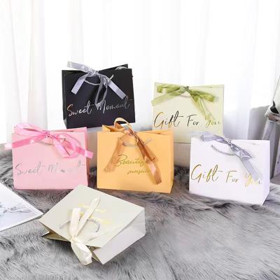 China Recyclable Custom Printed Logo Luxury Paper Shopping Paper Gift Bags Packaging With Ribbon Rope Handle for sale