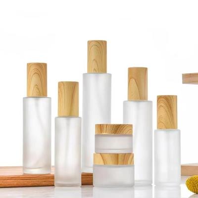 China 20ml 60ml 100ml 50g Glass Bottle Set Cosmetic Lotion Pump/Spray/Toner Vials Set With Wood Grain Lid for sale