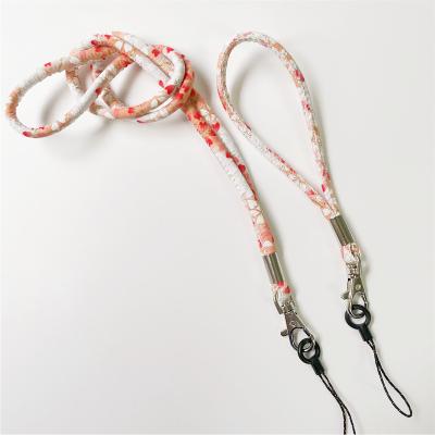 China Lovely Beautiful Floral Pattern Fabric Round Rope Mobile Phone Holder Leather Lanyard Lanyard for sale