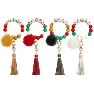 China Causal Silicone Tassel Christmas Pearl Fur Ball Key Ring Key Chain Wooden Woman Key Ring for sale