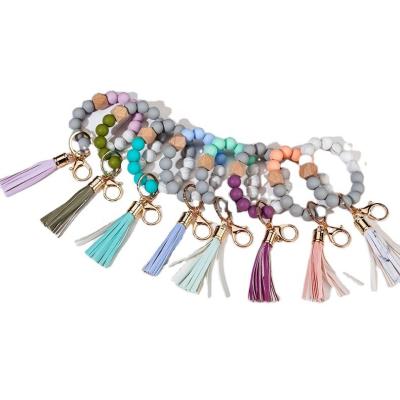 China Causal Ring Wooden Colorful Bead Woman hot selling key tassel silicone key chain for sale