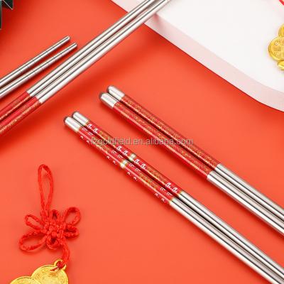 China Chinese household 304 stainless steel tableware color laser painting pattern non-slip radiant red chopsticks gift new year for sale