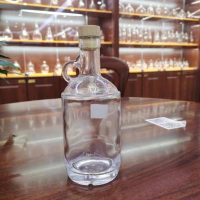 China High quality 750ml empty glass beverage bottle with cork for liquor, vodka with handle bottles for sale