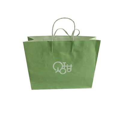 China Recyclable Custom Logo Ribbon Warm White Kraft Paper Garment Kraft Shopping Paper Bag for sale