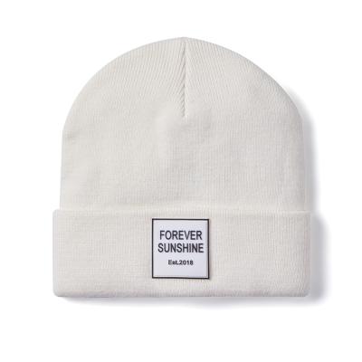 China COMMON wholesale white acrylic knitted beanie with logo color patch winter beanie white high quality unisex leather hats for sale