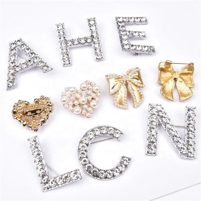 China The Other Wholesale Glass Diamond Pearl Elegant Bow Brooch Pin Diy Shoes Clothes Bags Crystal Letter Buckle Alloy Accessories Decorations for sale