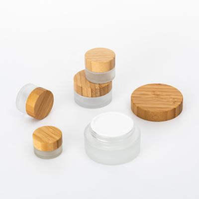 China Natural and evirnmental full capacity face cream cosmetic luxury glass jars with bamboo lid for sale