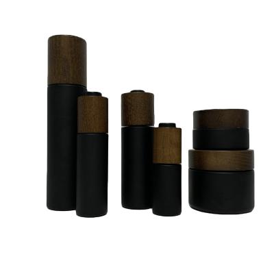 China Eco-friendly Personal Care Ash Tree Wooden Cap Or Dropper Collar For Cosmetic Packaging Black Glass Bottle Jars for sale