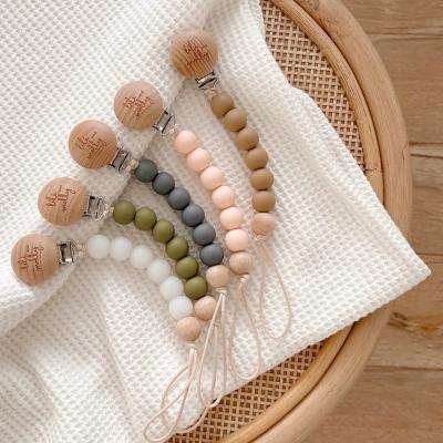 China Low MOQ custom made BPA free silicone beads pacifiers cut beads pacifier chains wooden chain with logo for sale