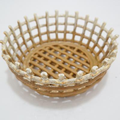 China Sustainable Irregular Handcrafted Desktop Kitchen Organize Basket Fruit Restaurant Ceramic Hollow Weave Basket for sale