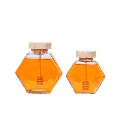 China Sustainable Empty Hexagonal Shaped Glass Honey Jars With Wooden Bamboo Dripper for sale