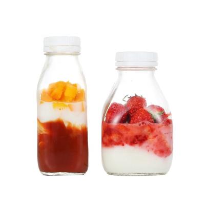 China Beverage 300ml 400ml 500ml 1000ml Square Shape Glass Milk Bottle With Plastic Lid for sale