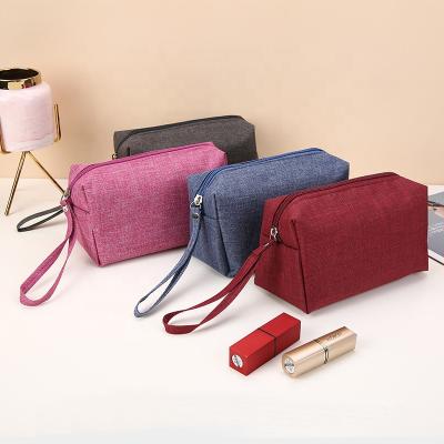 China Wholesale Cosmetic Pouch Bags Mixed Color Nylon Zippered High Quality And Durable Nylon Cosmetic Bag Hand Holding Cosmetic Bag With Handle for sale