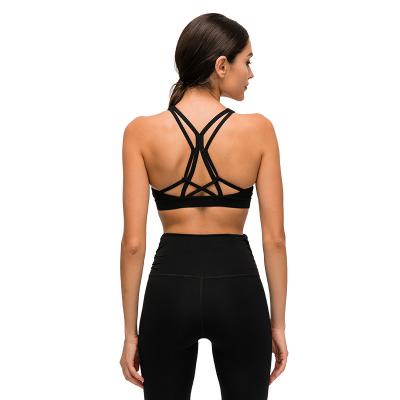 China Beautiful Breathable Strappy Workout Sports Bras Tops Women Bare-Feel Wireless Yoga Fitness Bras Padded Sports Tops for sale