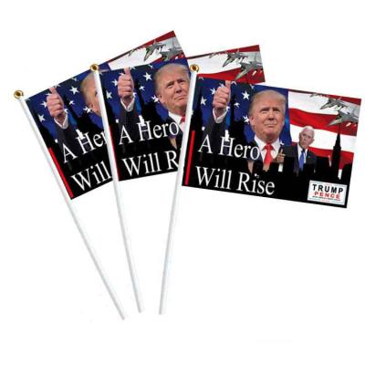 China Decoration Wholesale Custom 14*21cm 100D Polyester A Hero Will Rise Hand Trump 2024 Waving Flag For Decoration for sale