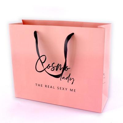 China Recycled Materials Custom Luxury Pink Gift Clothing Shopping Packaging Paper Bag WithLuxury Rope Handle For Cosmetic Packaging for sale