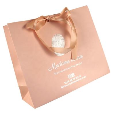 China Retail Eco Friendly Hot Pink Silver Stamping Shopping Paper Bag With Bow Ribbon for sale