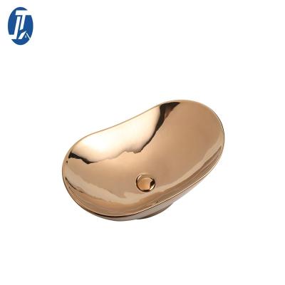 China Modern Luxury Gold Oval Basin Gold Oval Washbasin Ceramic Bathroom Gold Plating Hand Basin Hotel Counter Top Art Ceramic Sink for sale