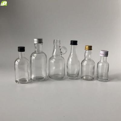 China Spirit Liquor Factory Price Liquor Bottle Metal Closure Round Ropp Lid 30ml 50ml 100ml Mini Clear Flint Glass Spirit for sale