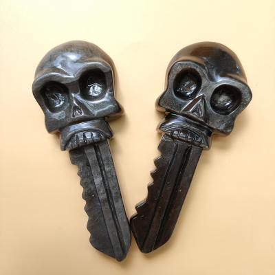 China Europe Wholesale Natural Healing Crystal Folk Crafts 110mm Sliver Obsidian Skull Stone Key For Home Decor for sale