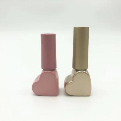 China Beautiful Cosmetic Heart Shaped Pink Plating Empty Nail Polish Glass Bottle With Brush for sale