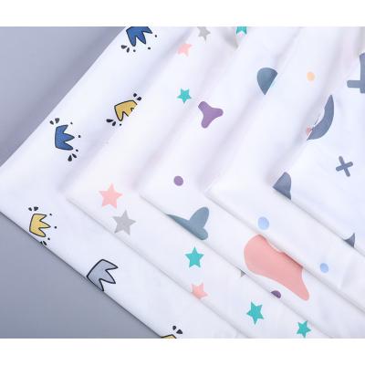 China Anti-static 180 GSM milk silk fabric cartoon style crown printing factory outlet polyester fabric for T-shirt/pajamas for sale