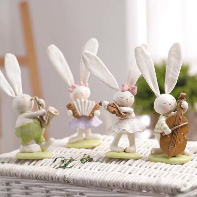 China Handmade Carved Easter Fun Decorations Cute Animal Rabbit Resin Small Animal Musical Instrument Carved Animal Statue for sale